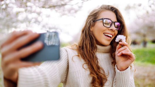 girl takes selfie with flower in hand