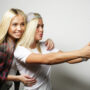 girls taking selfies on tablet